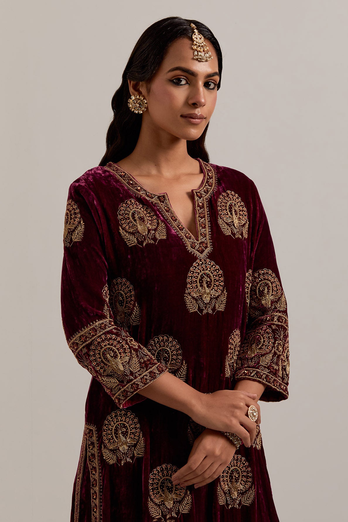 Plum silk velvet straight kurta set with sequins, zardozi, zari embroidered peacock boota all-over the kurta, highlighted with contrast bead work.