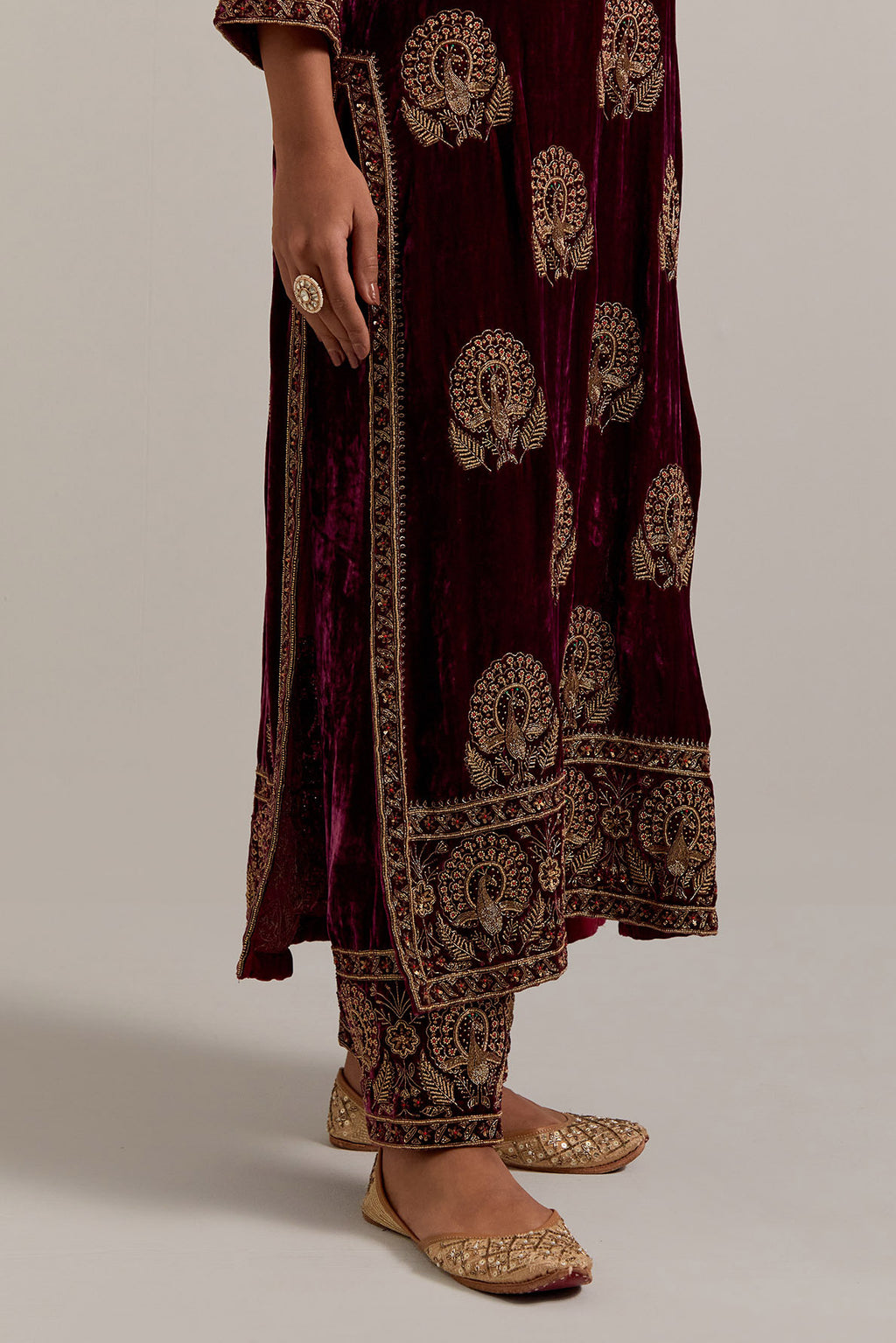 Plum silk velvet straight kurta set with sequins, zardozi, zari embroidered peacock boota all-over the kurta, highlighted with contrast bead work.