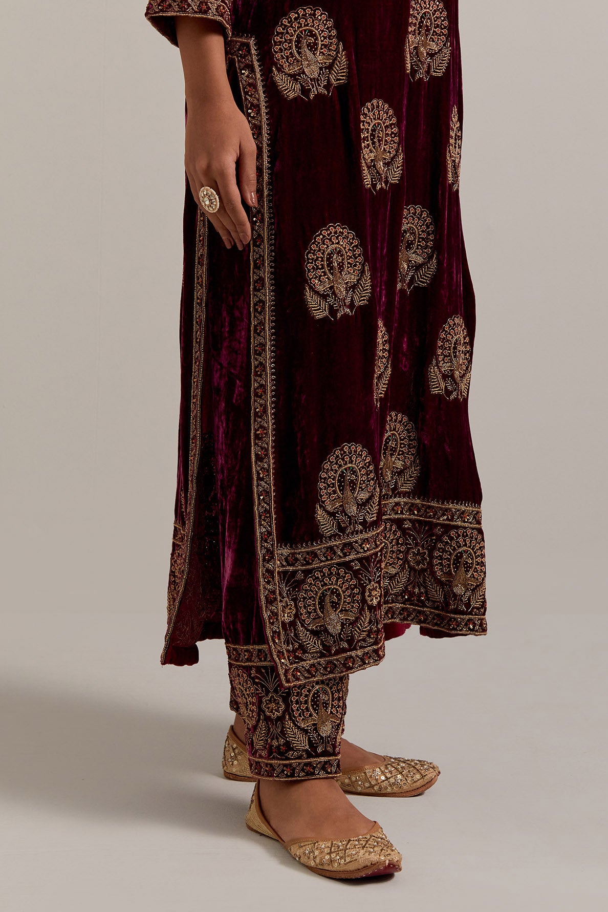 Plum silk velvet straight kurta set with sequins, zardozi, zari embroidered peacock boota all-over the kurta, highlighted with contrast bead work.
