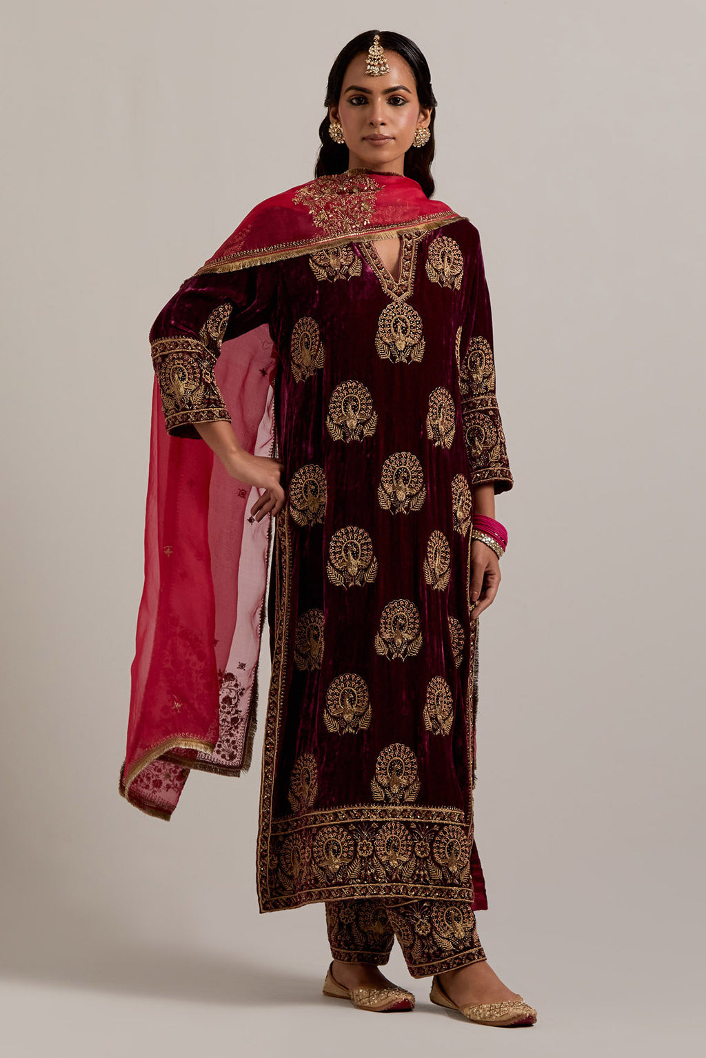 Plum silk velvet straight kurta set with sequins, zardozi, zari embroidered peacock boota all-over the kurta, highlighted with contrast bead work.
