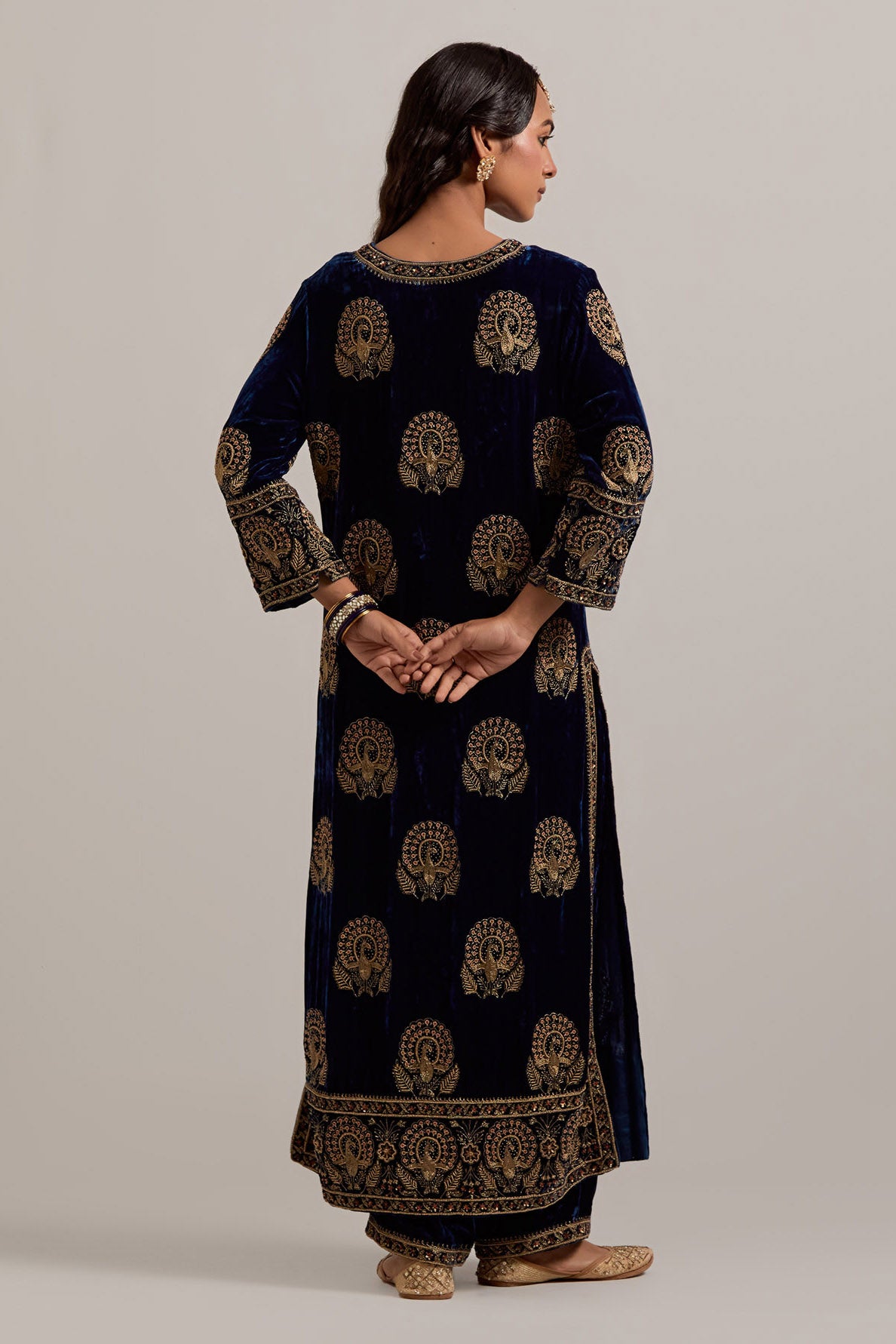 Navy blue silk velvet straight kurta set with sequins, zardozi, zari embroidered peacock boota all-over the kurta, highlighted with contrast bead work.