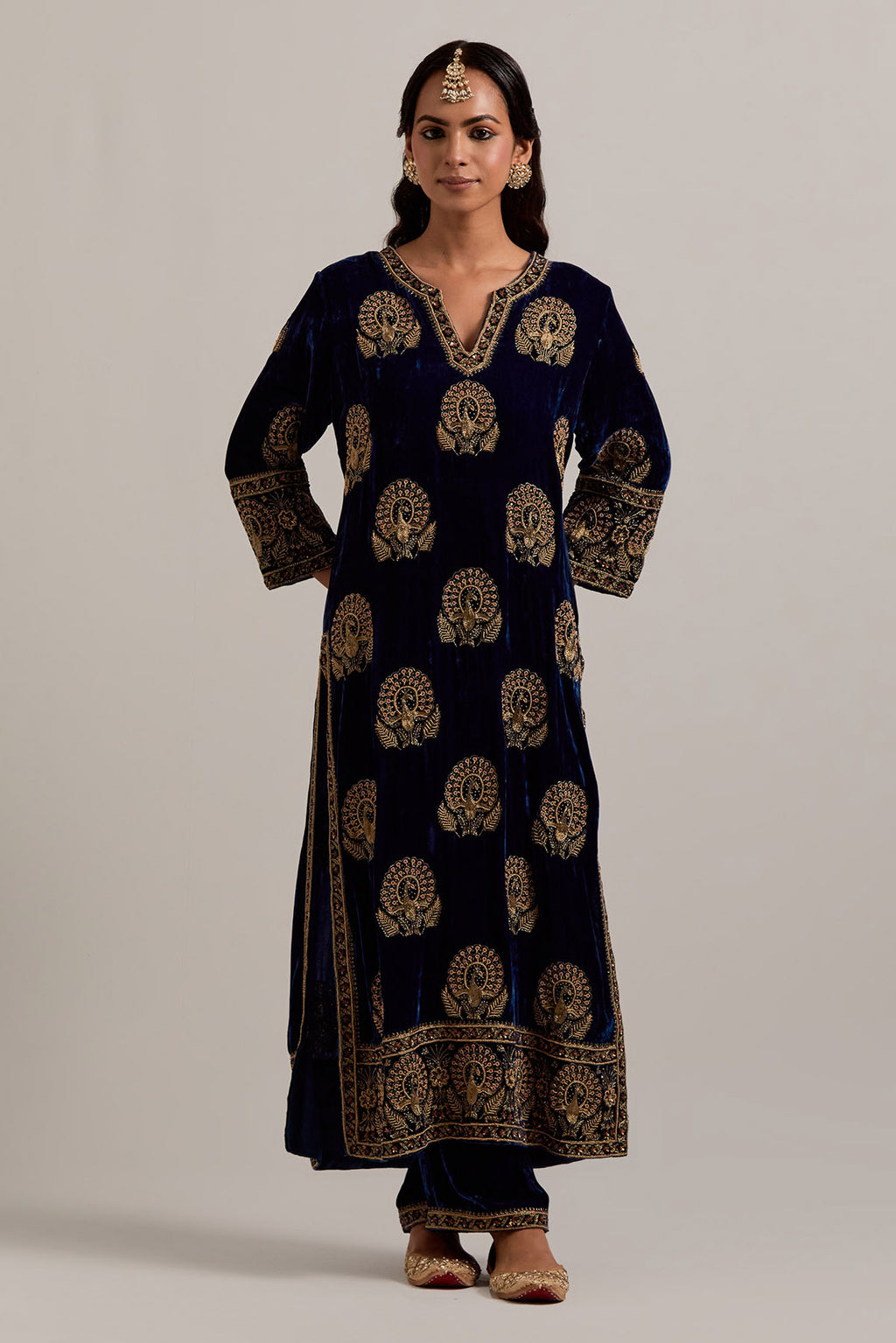 Navy blue silk velvet straight kurta set with sequins, zardozi, zari embroidered peacock boota all-over the kurta, highlighted with contrast bead work.