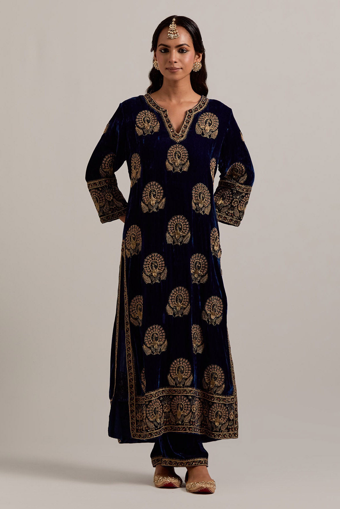 Navy blue silk velvet straight kurta set with sequins, zardozi, zari embroidered peacock boota all-over the kurta, highlighted with contrast bead work.
