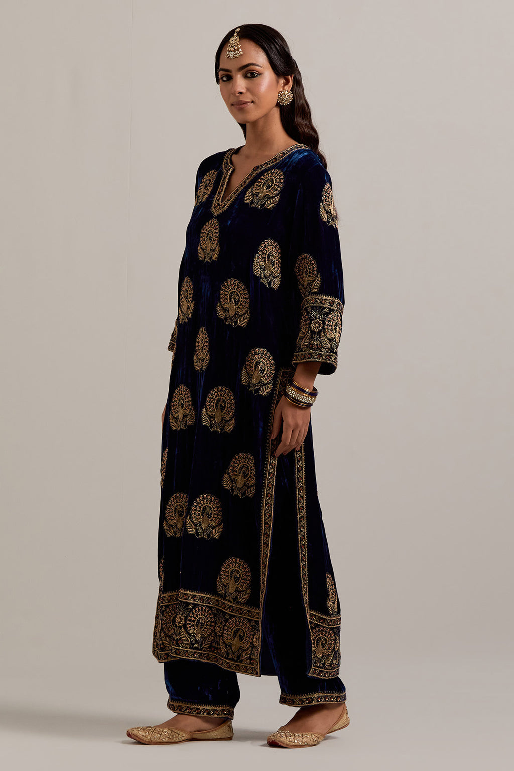 Navy blue silk velvet straight kurta set with sequins, zardozi, zari embroidered peacock boota all-over the kurta, highlighted with contrast bead work.