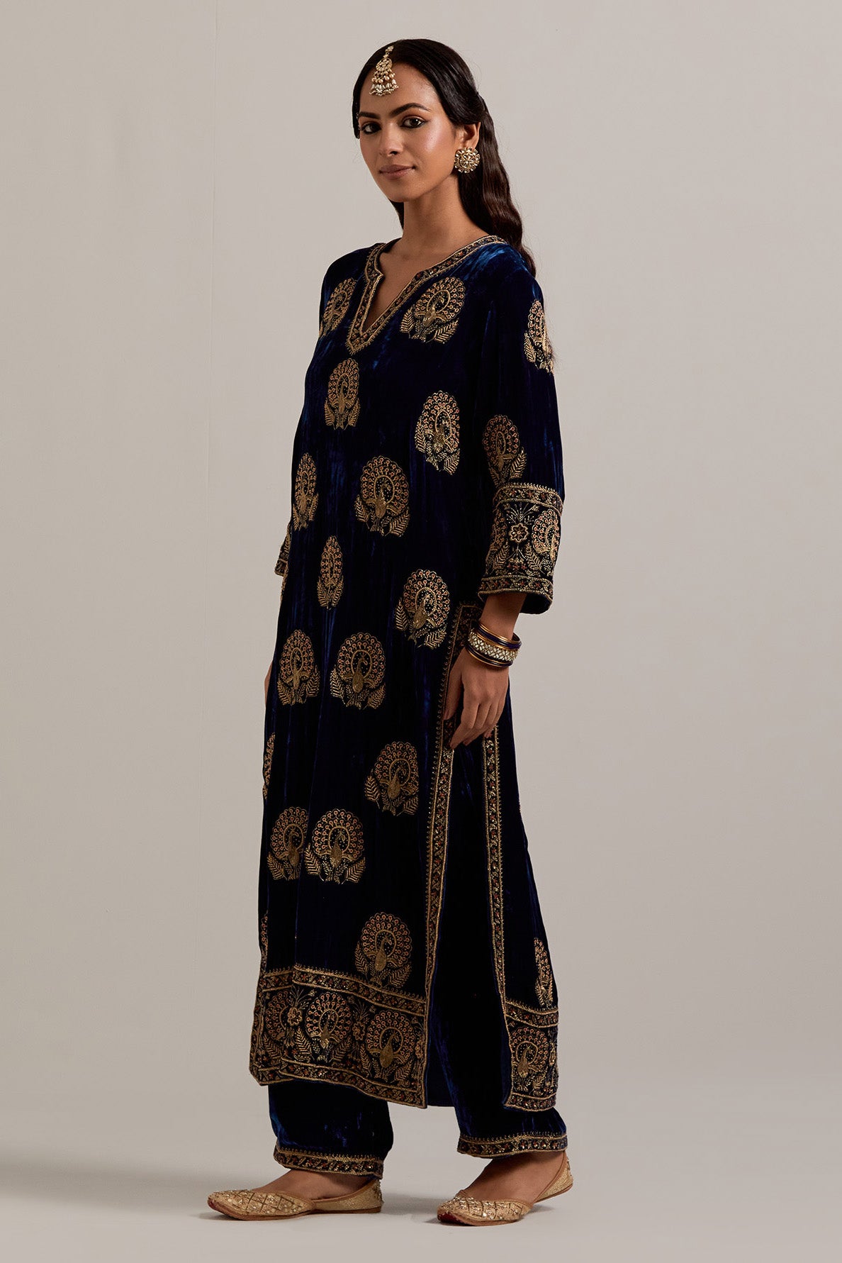 Navy blue silk velvet straight kurta set with sequins, zardozi, zari embroidered peacock boota all-over the kurta, highlighted with contrast bead work.