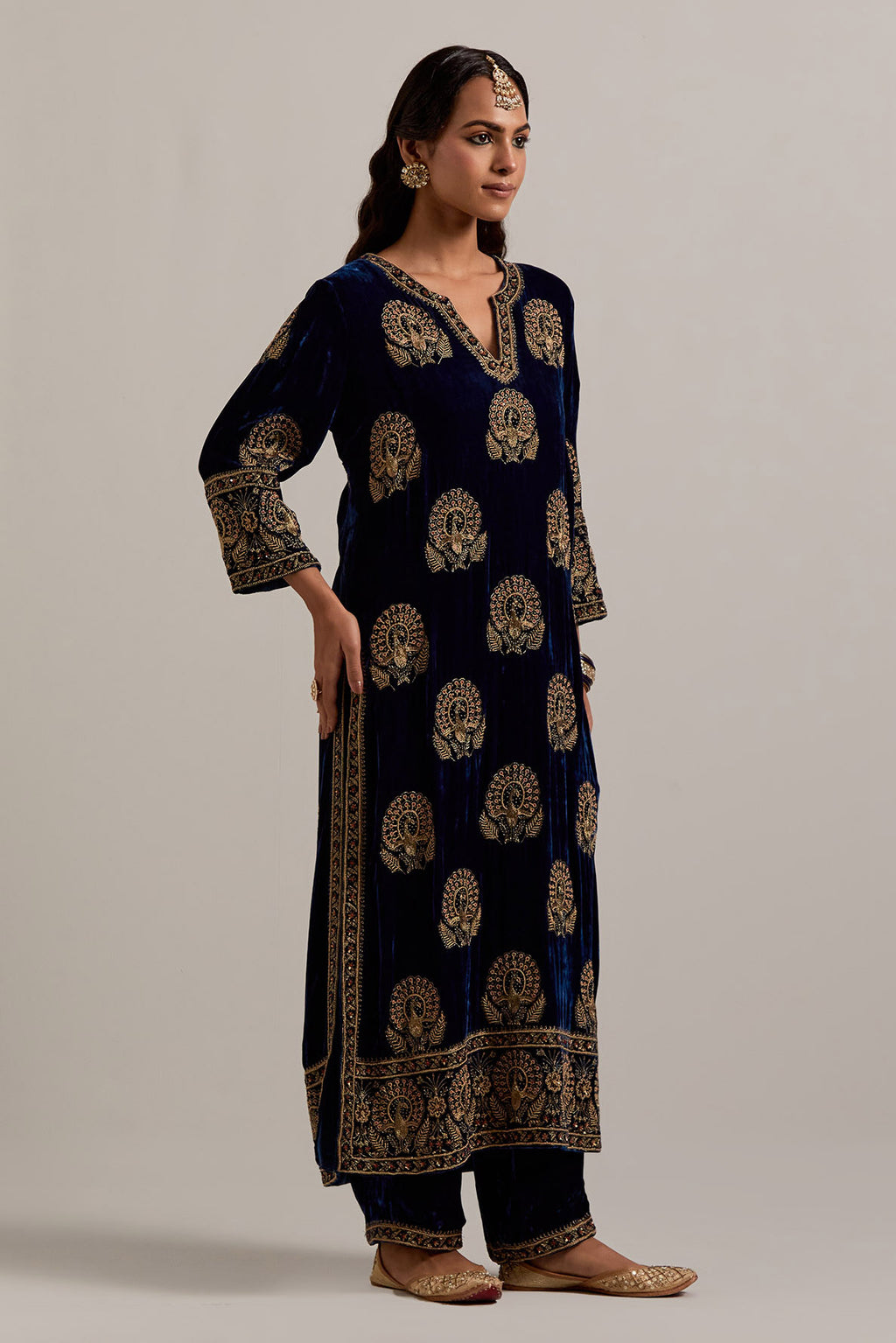 Navy blue silk velvet straight kurta set with sequins, zardozi, zari embroidered peacock boota all-over the kurta, highlighted with contrast bead work.
