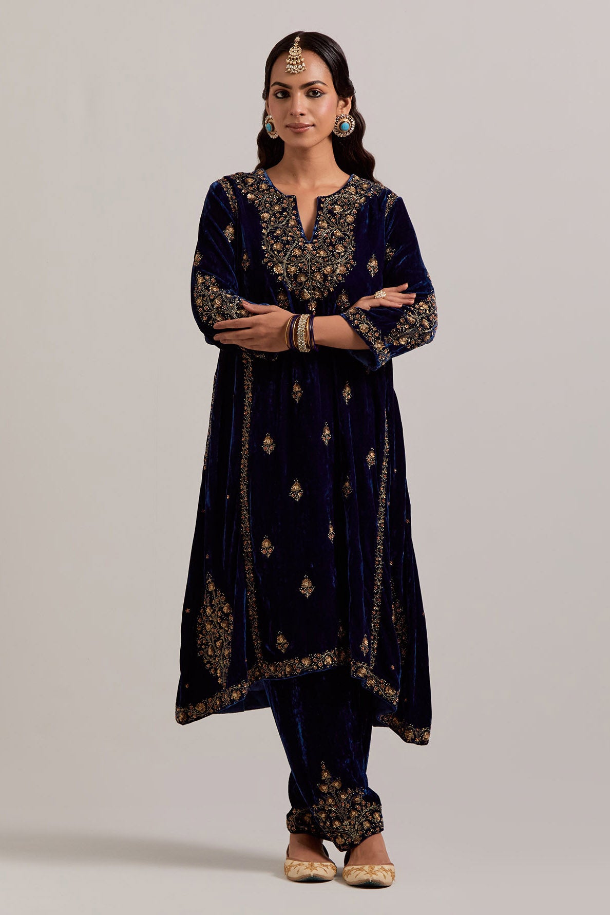 Navy blue easy fit A-line, panelled, short kurta set in silk velvet with all-over hand embroidery at the neck, sleeves and hem.