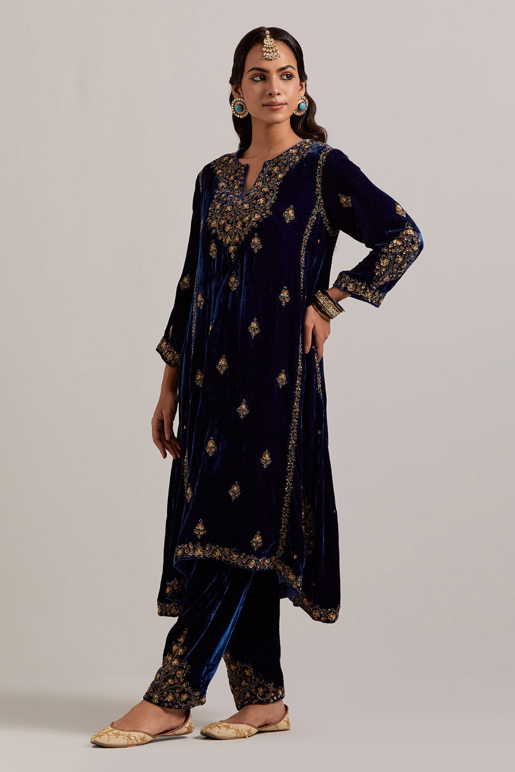 Navy blue easy fit A-line, panelled, short kurta set in silk velvet with all-over hand embroidery at the neck, sleeves and hem.