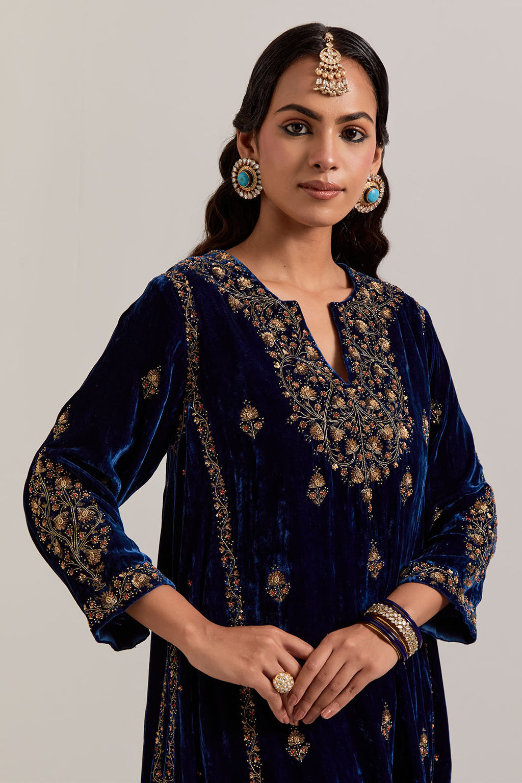 Navy blue easy fit A-line, panelled, short kurta set in silk velvet with all-over hand embroidery at the neck, sleeves and hem.