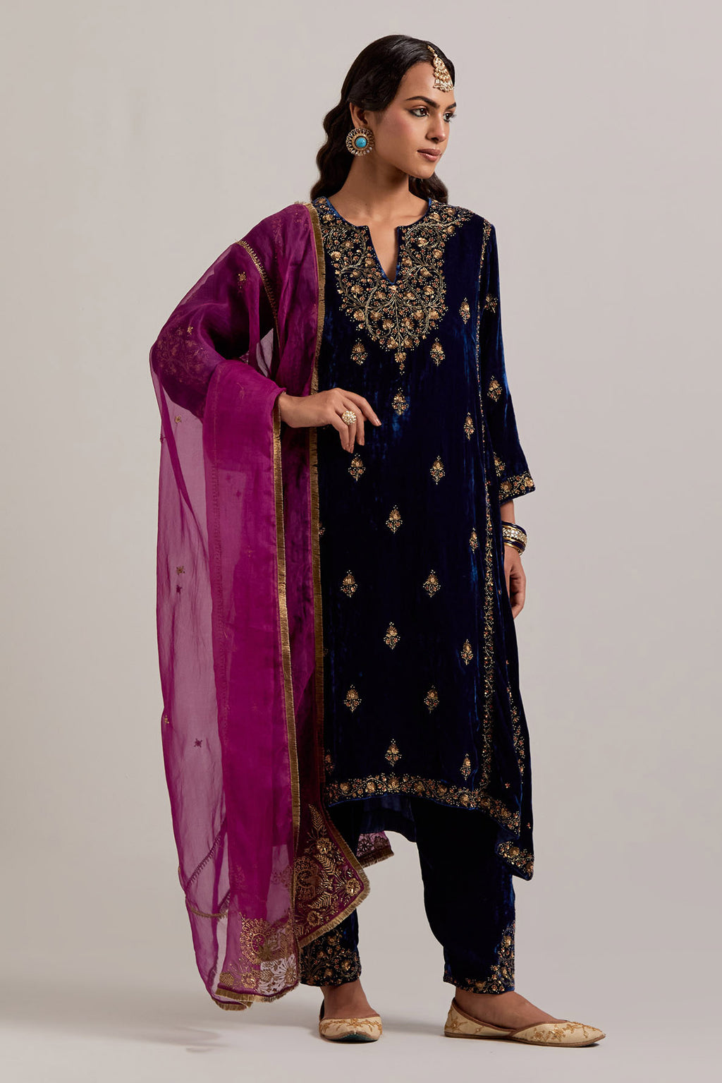 Navy blue easy fit A-line, panelled, short kurta set in silk velvet with all-over hand embroidery at the neck, sleeves and hem.