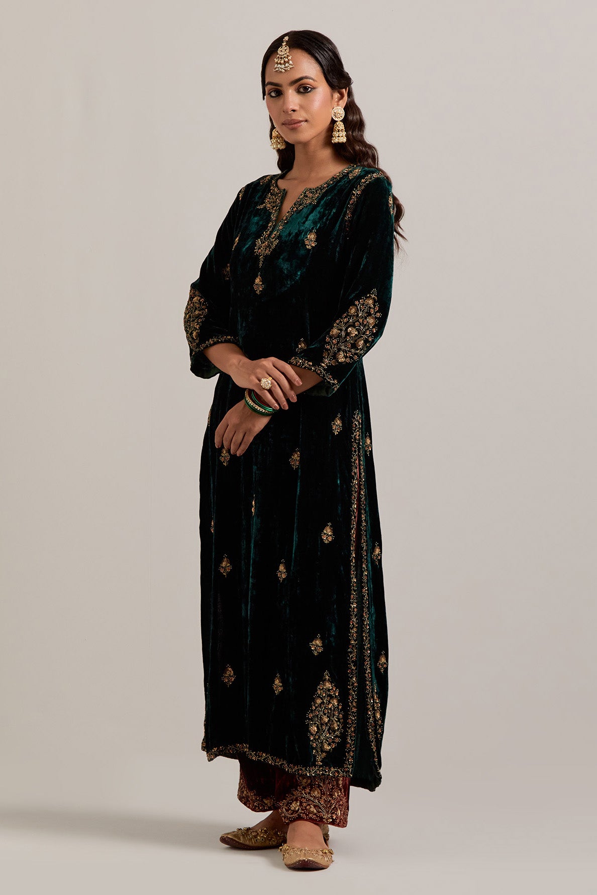 Dark green straight Silk Velvet kurta set with all-over hand-embroidered small floral booti with sequins, zardozi, bead and zari work.
