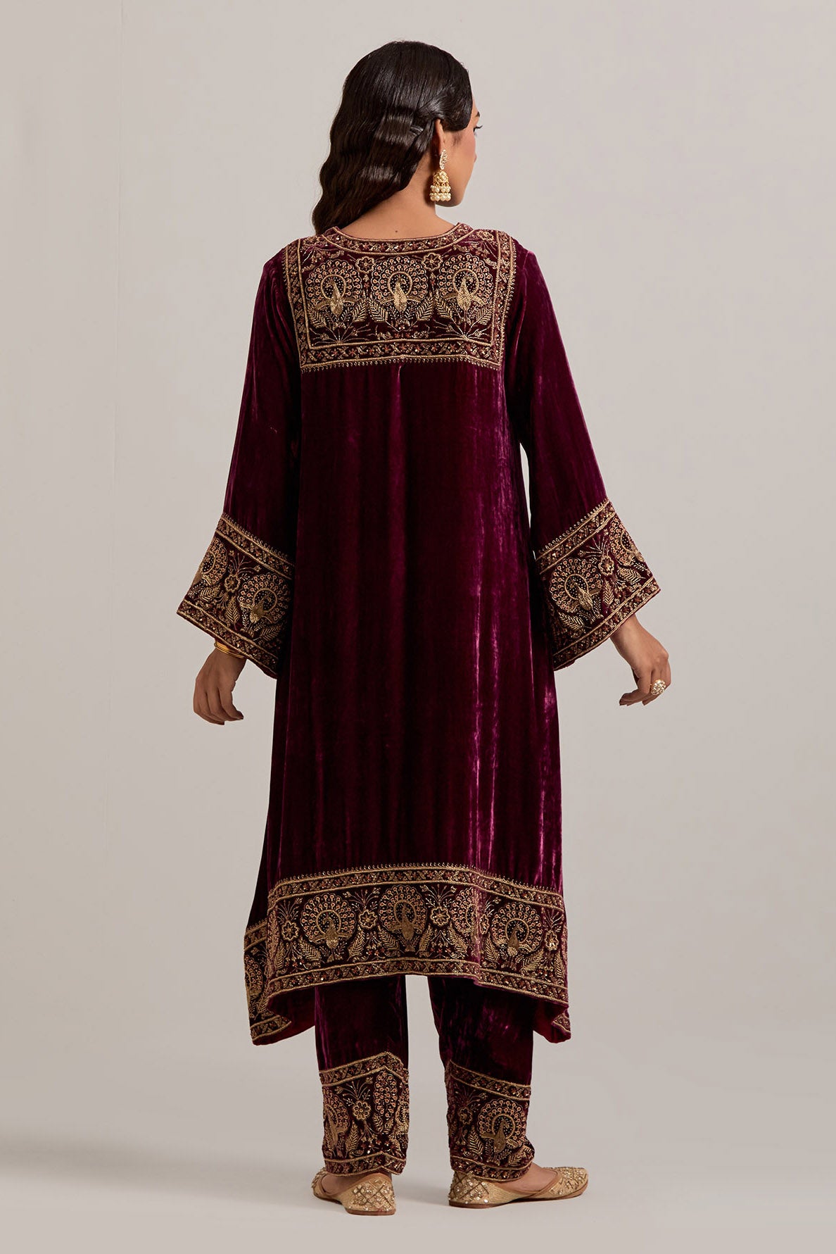 Plum silk velvet short easy fit A-line kurta set with sequins, zardozi, bead and zari embroidered big border at hem, detailed with contrast colored bead.
