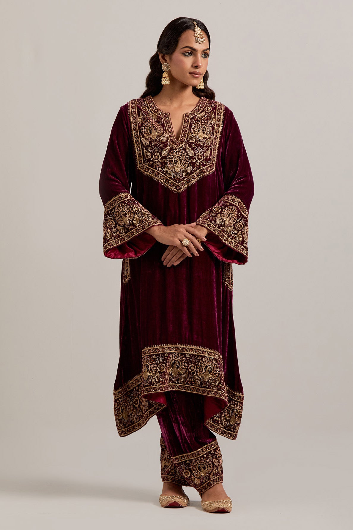 Plum silk velvet short easy fit A-line kurta set with sequins, zardozi, bead and zari embroidered big border at hem, detailed with contrast colored bead.