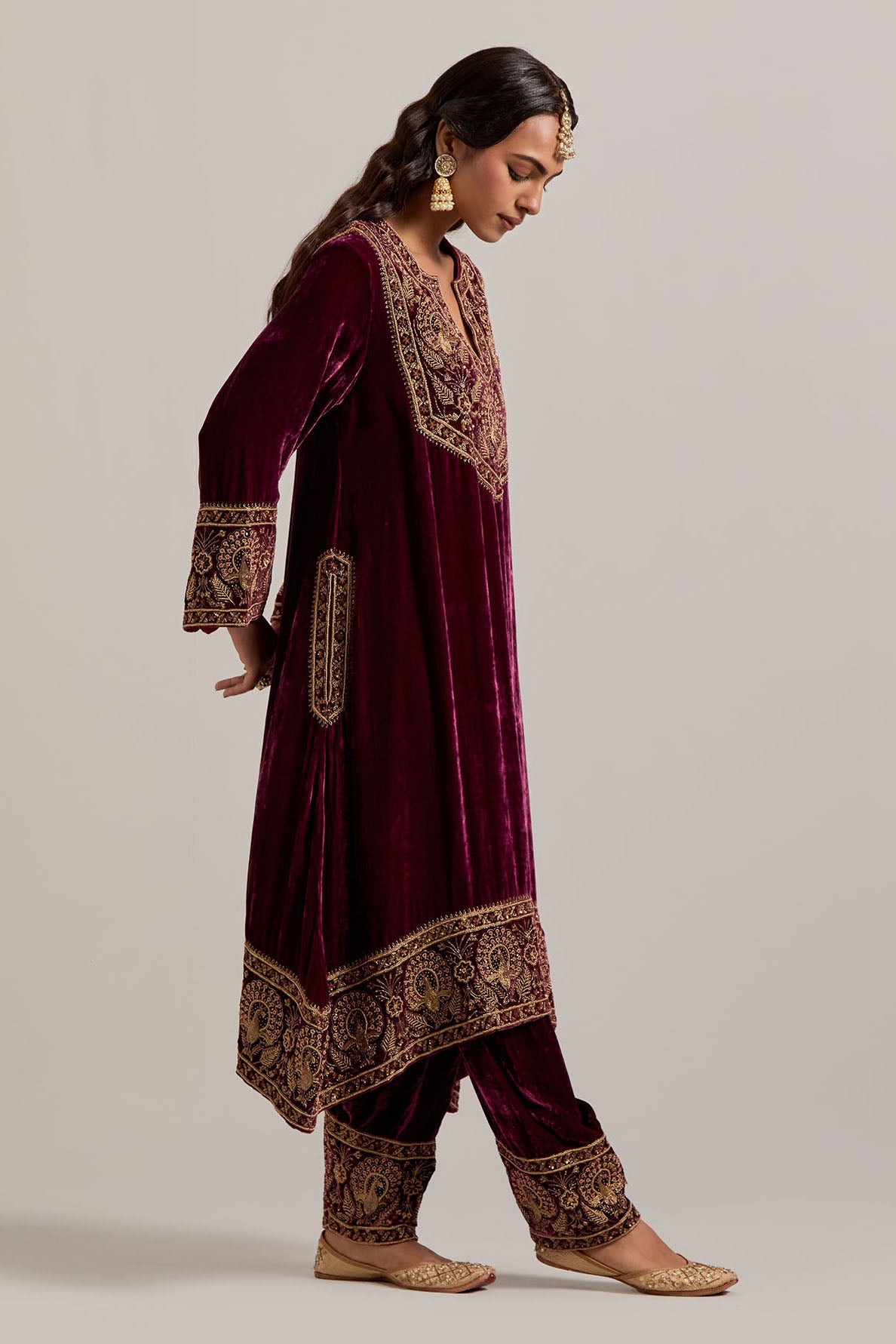 Plum silk velvet short easy fit A-line kurta set with sequins, zardozi, bead and zari embroidered big border at hem, detailed with contrast colored bead.