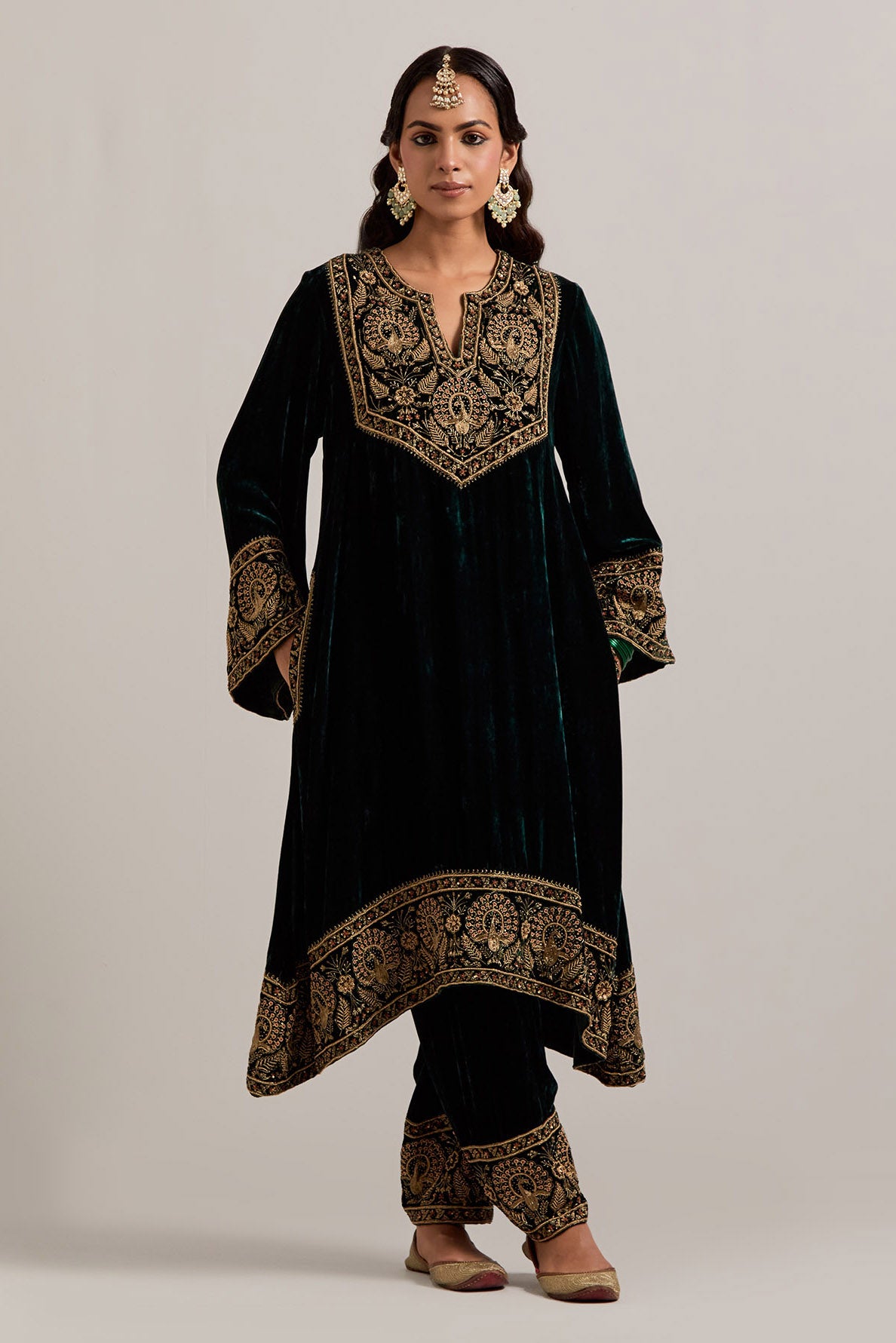 Dark green silk velvet short easy fit A-line kurta set with sequins, zardozi, bead and zari embroidered big border at hem, detailed with contrast colored bead.