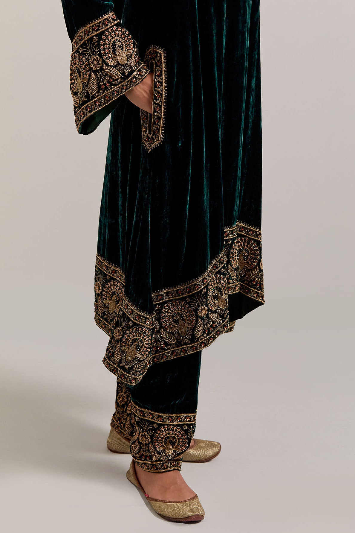 Dark green silk velvet short easy fit A-line kurta set with sequins, zardozi, bead and zari embroidered big border at hem, detailed with contrast colored bead.