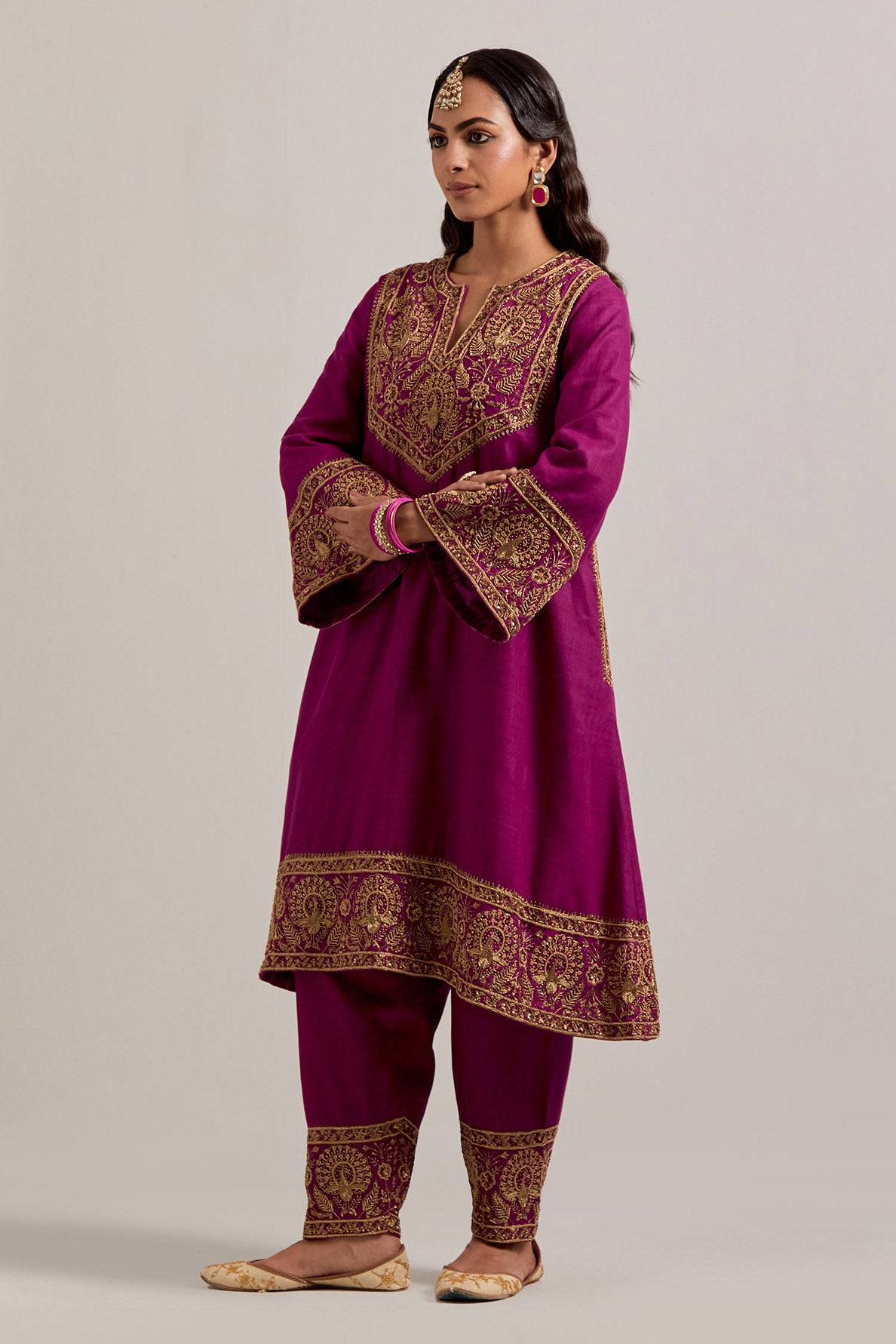 Fuchsia Matka silk short easy fit A-line kurta set with sequins, zardozi, bead and zari embroidered big border at hem, detailed with contrast colored bead.