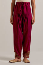 Ruby red Matka silk salwar, highlighted with hand embroidered bead, sequins, zardozi and zari boota at bottom hem.