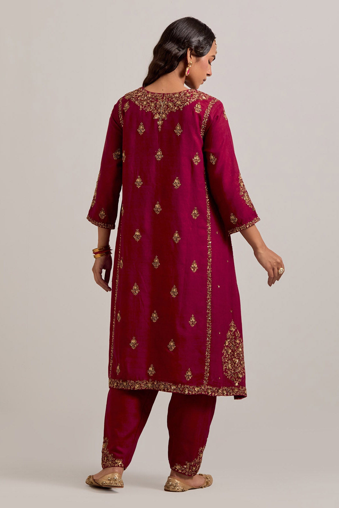 Ruby red easy fit A-line, panelled, short kurta set in Matka silk with all-over hand embroidery at the neck, sleeves and hem.