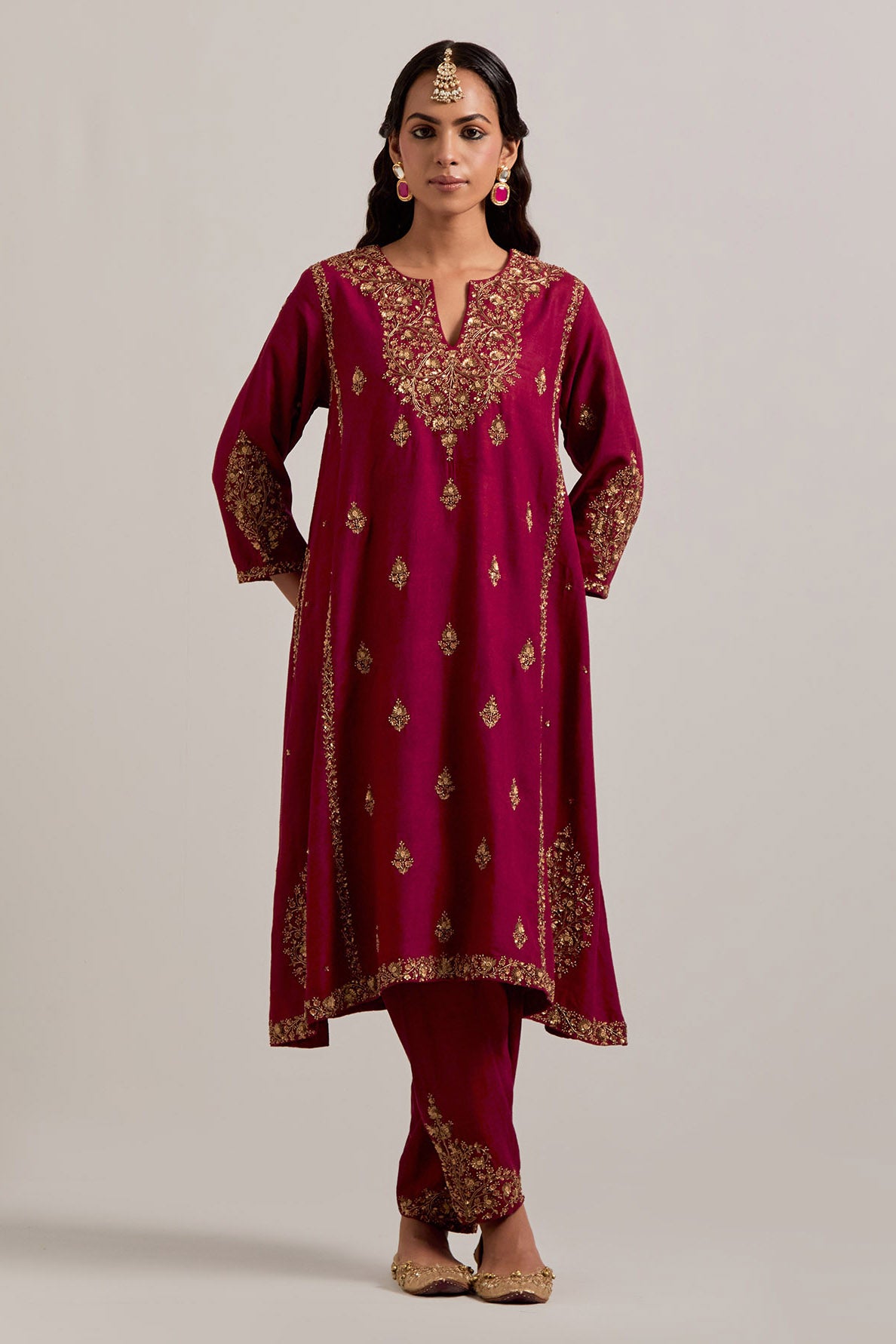Ruby red easy fit A-line, panelled, short kurta set in Matka silk with all-over hand embroidery at the neck, sleeves and hem.
