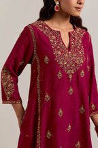 Ruby red easy fit A-line, panelled, short kurta set in Matka silk with all-over hand embroidery at the neck, sleeves and hem.