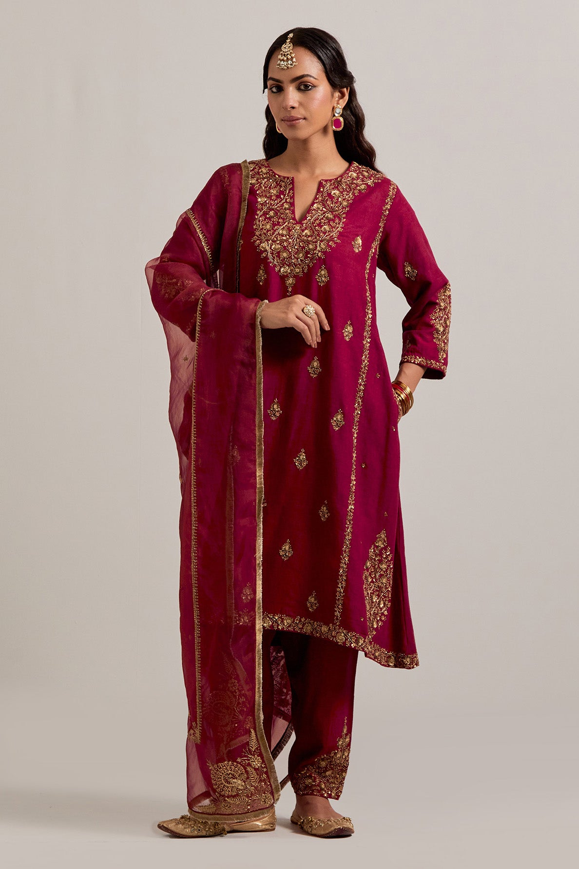 Ruby red easy fit A-line, panelled, short kurta set in Matka silk with all-over hand embroidery at the neck, sleeves and hem.