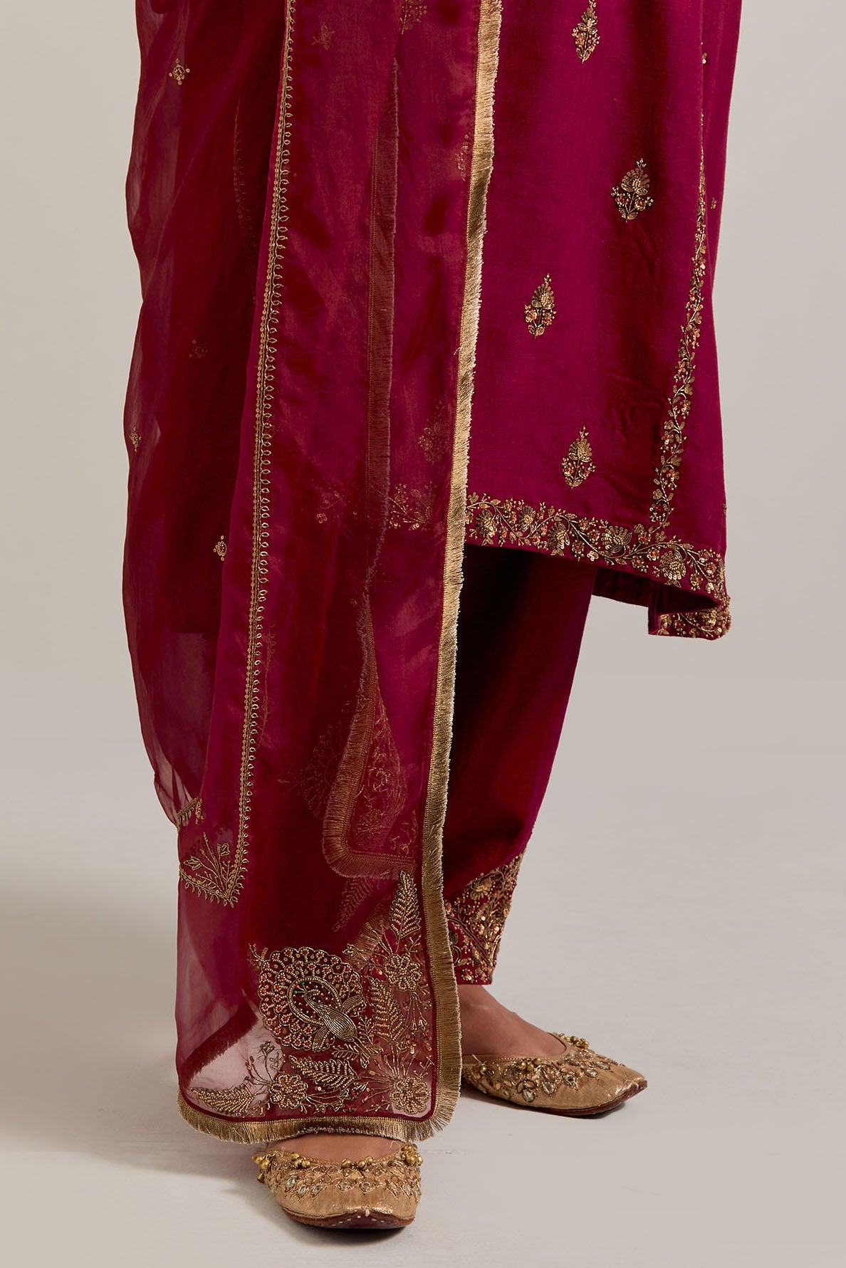 Ruby red easy fit A-line, panelled, short kurta set in Matka silk with all-over hand embroidery at the neck, sleeves and hem.