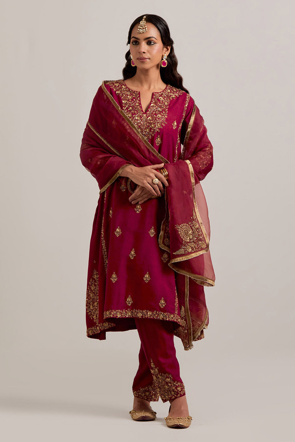 Ruby red easy fit A-line, panelled, short kurta set in Matka silk with all-over hand embroidery at the neck, sleeves and hem.