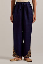 Navy blue Matka silk pants, highlighted with hand embroidered bead, sequins, zardozi and zari boota at bottom hem.