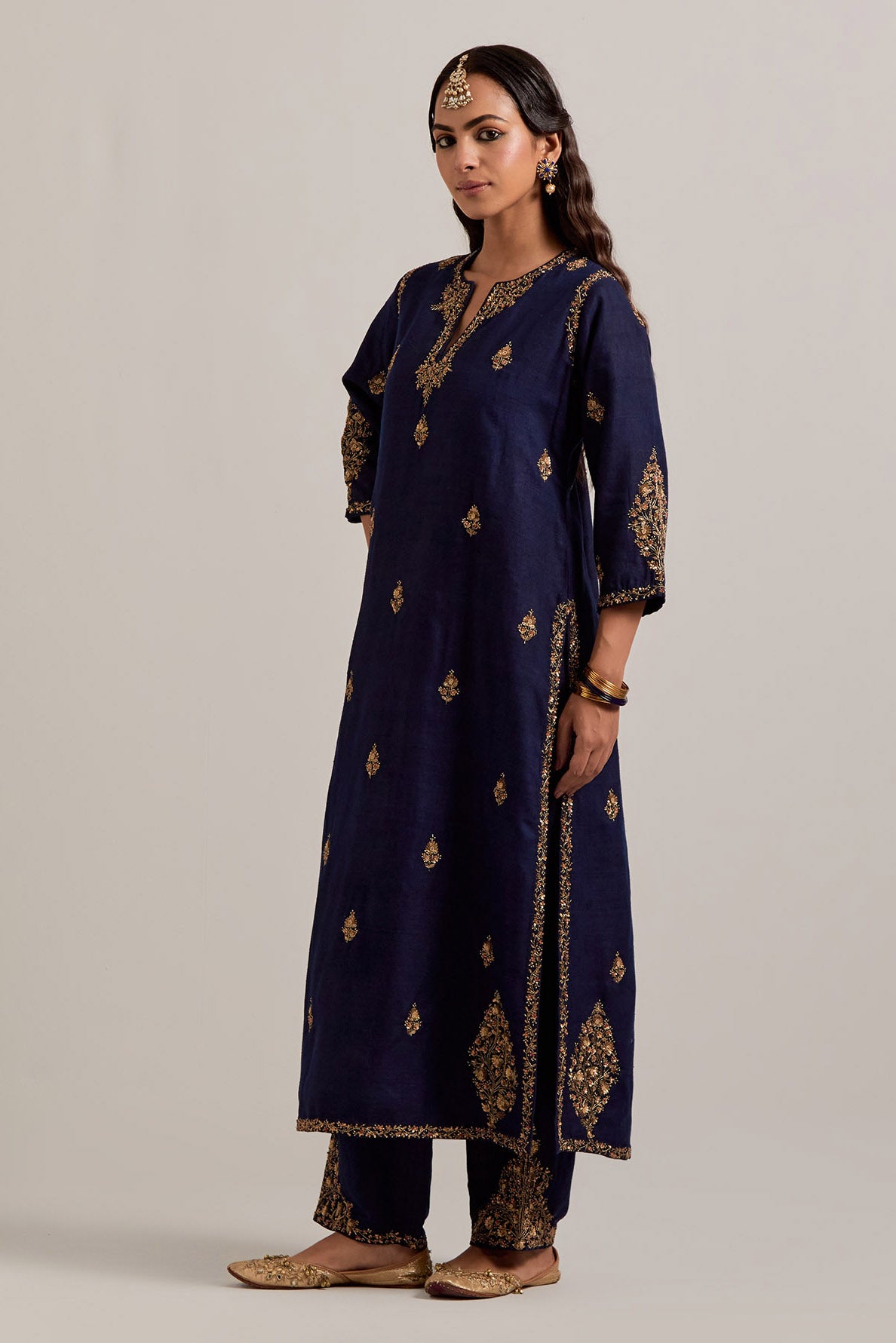 Navy blue straight Matka silk kurta set with all-over hand-embroidered small floral booti with sequins, zardozi, bead and zari work.