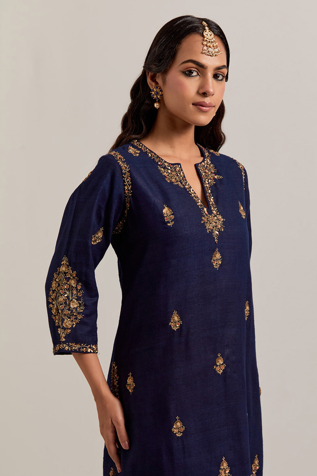Navy blue straight Matka silk kurta set with all-over hand-embroidered small floral booti with sequins, zardozi, bead and zari work.