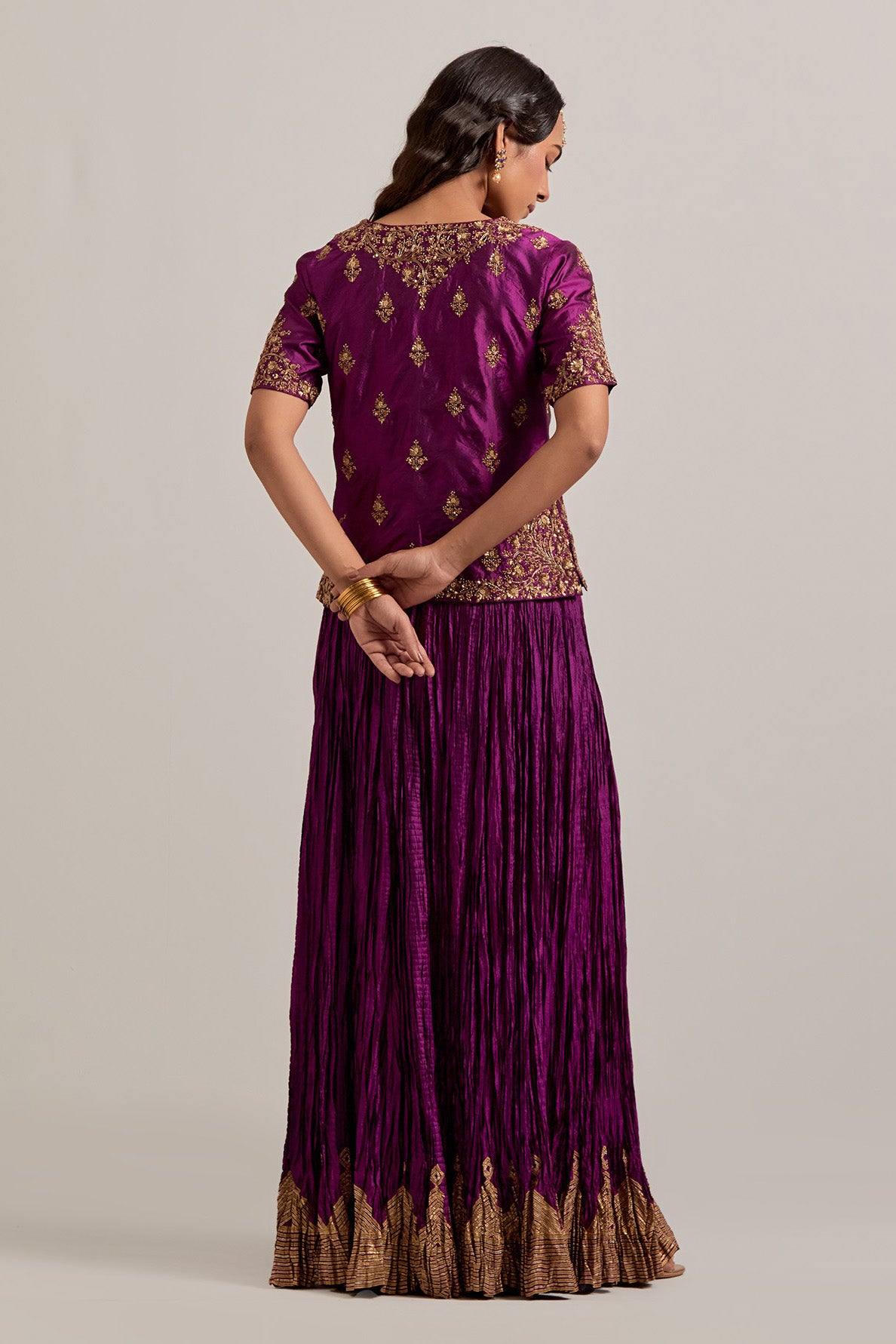 Wine Silk long choli set with all-over sequins, zardozi and zari handwork, highlighted with contrast-colored beads.
