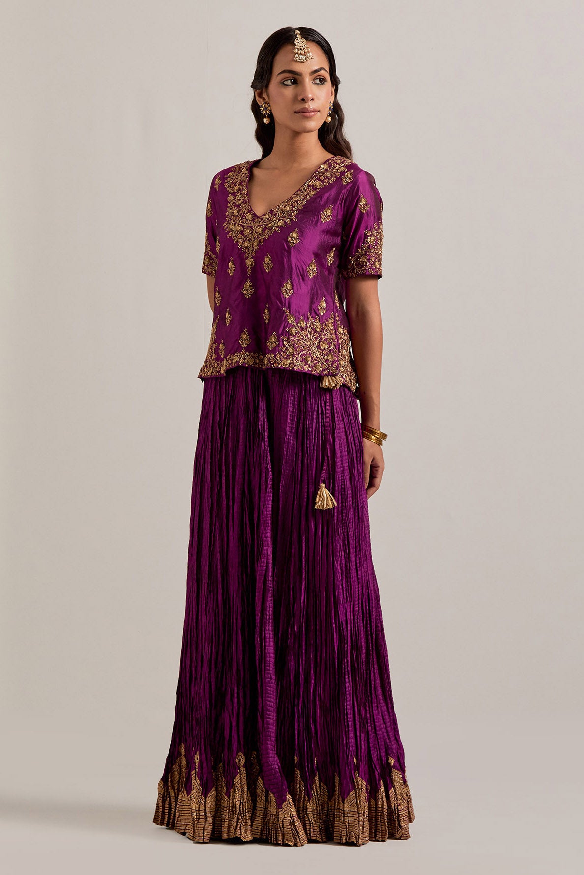 Wine Silk long choli set with all-over sequins, zardozi and zari handwork, highlighted with contrast-colored beads.