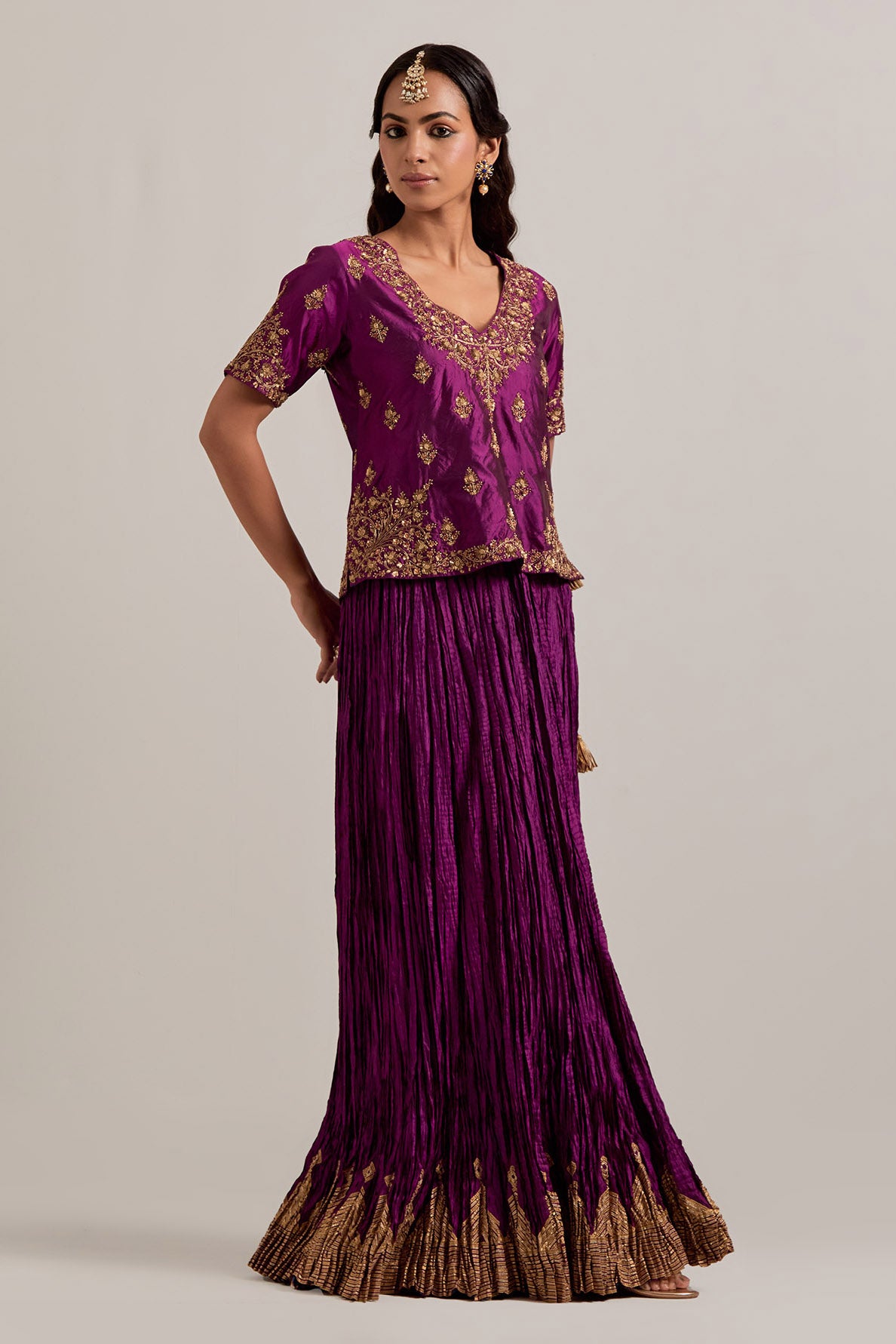 Wine Silk long choli set with all-over sequins, zardozi and zari handwork, highlighted with contrast-colored beads.