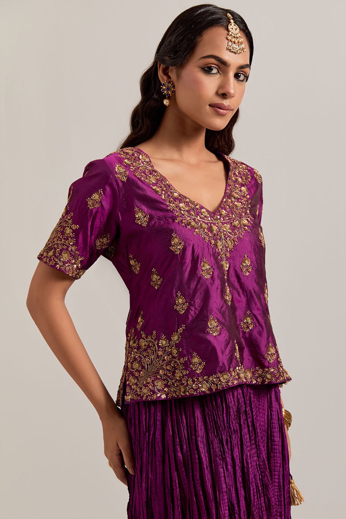 Wine Silk long choli set with all-over sequins, zardozi and zari handwork, highlighted with contrast-colored beads.