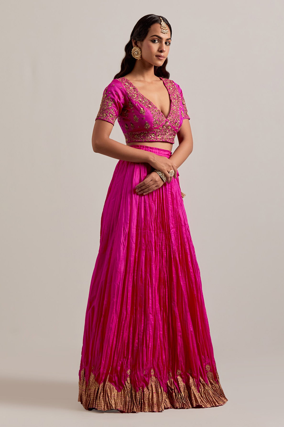Fuchsia Silk Choli set with all-over sequins, zardozi and zari handwork, highlighted with contrast-colored beads.
