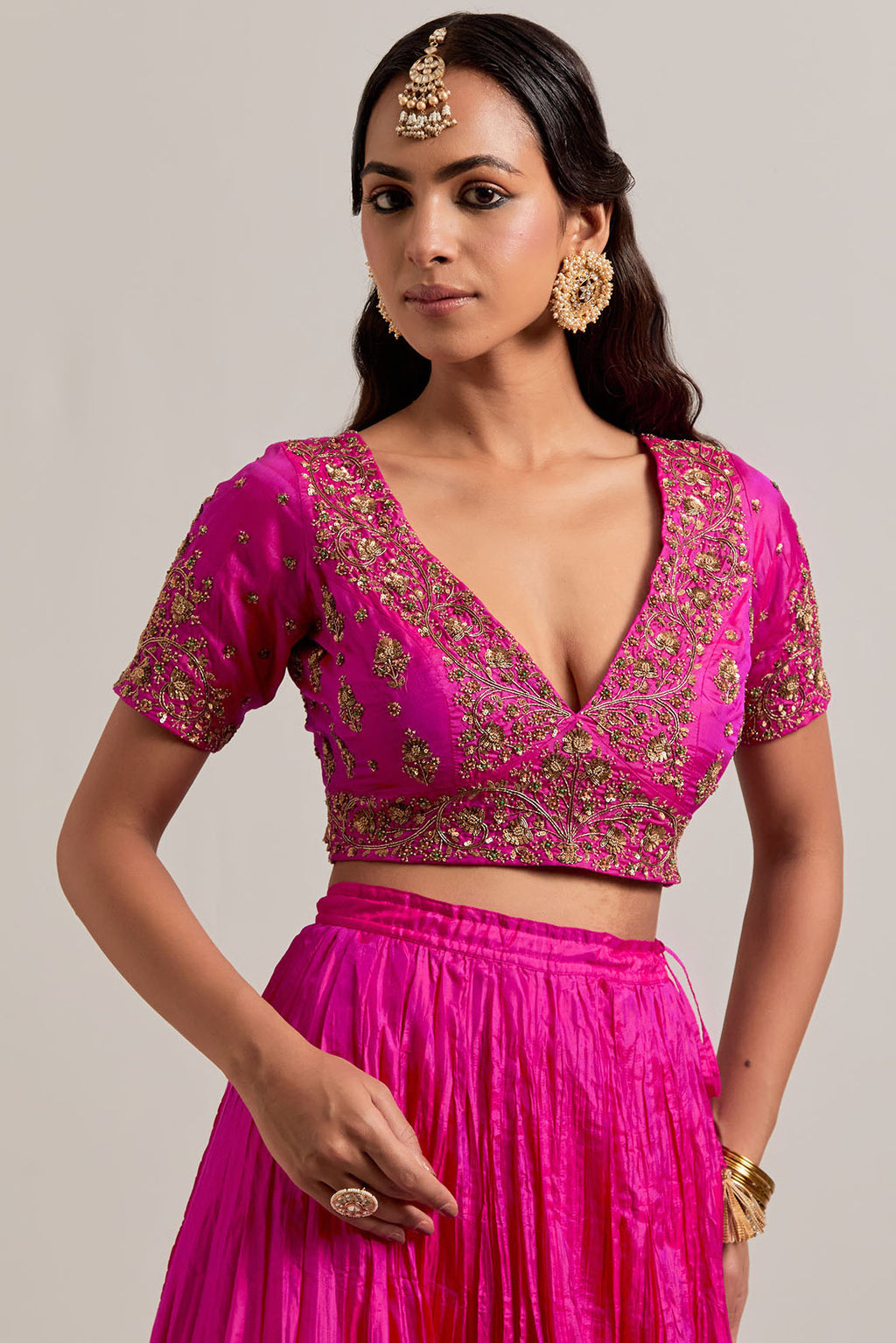 Fuchsia Silk Choli set with all-over sequins, zardozi and zari handwork, highlighted with contrast-colored beads.