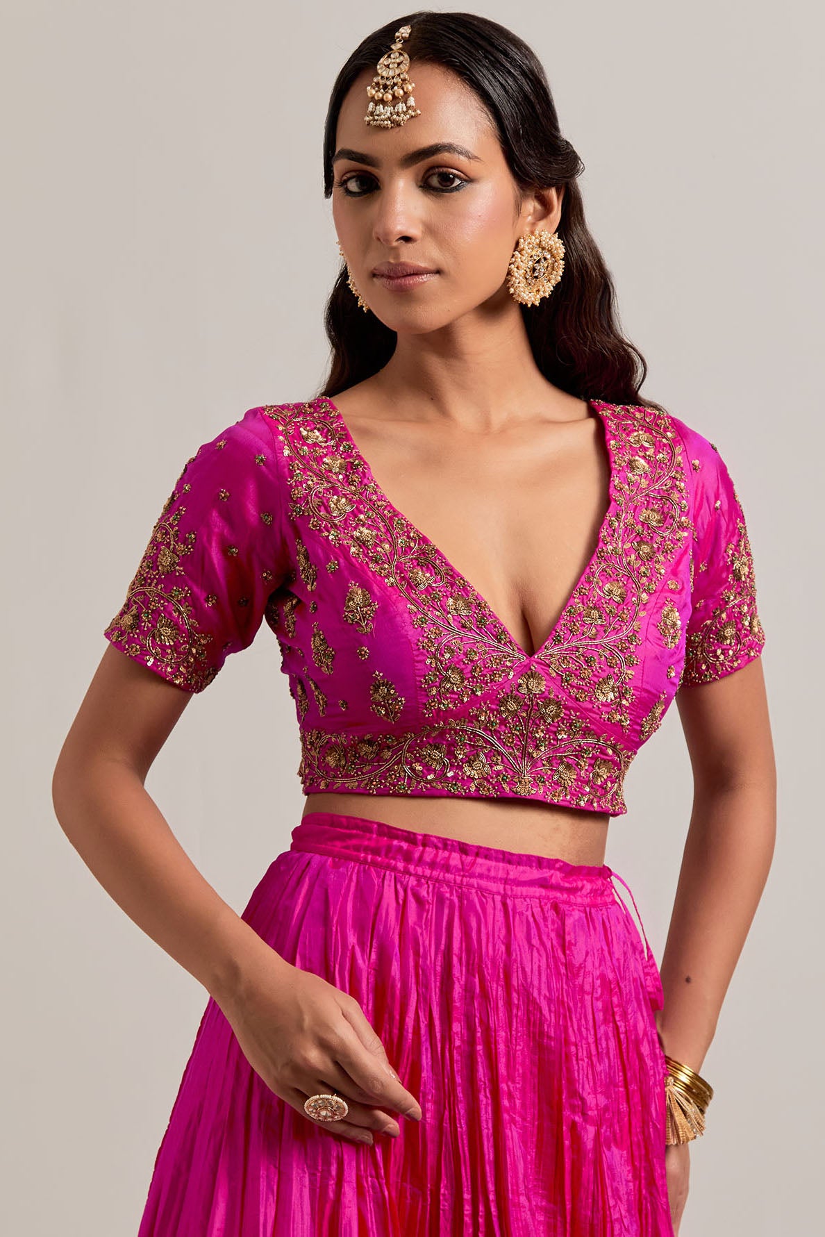 Fuchsia Silk Choli set with all-over sequins, zardozi and zari handwork, highlighted with contrast-colored beads.