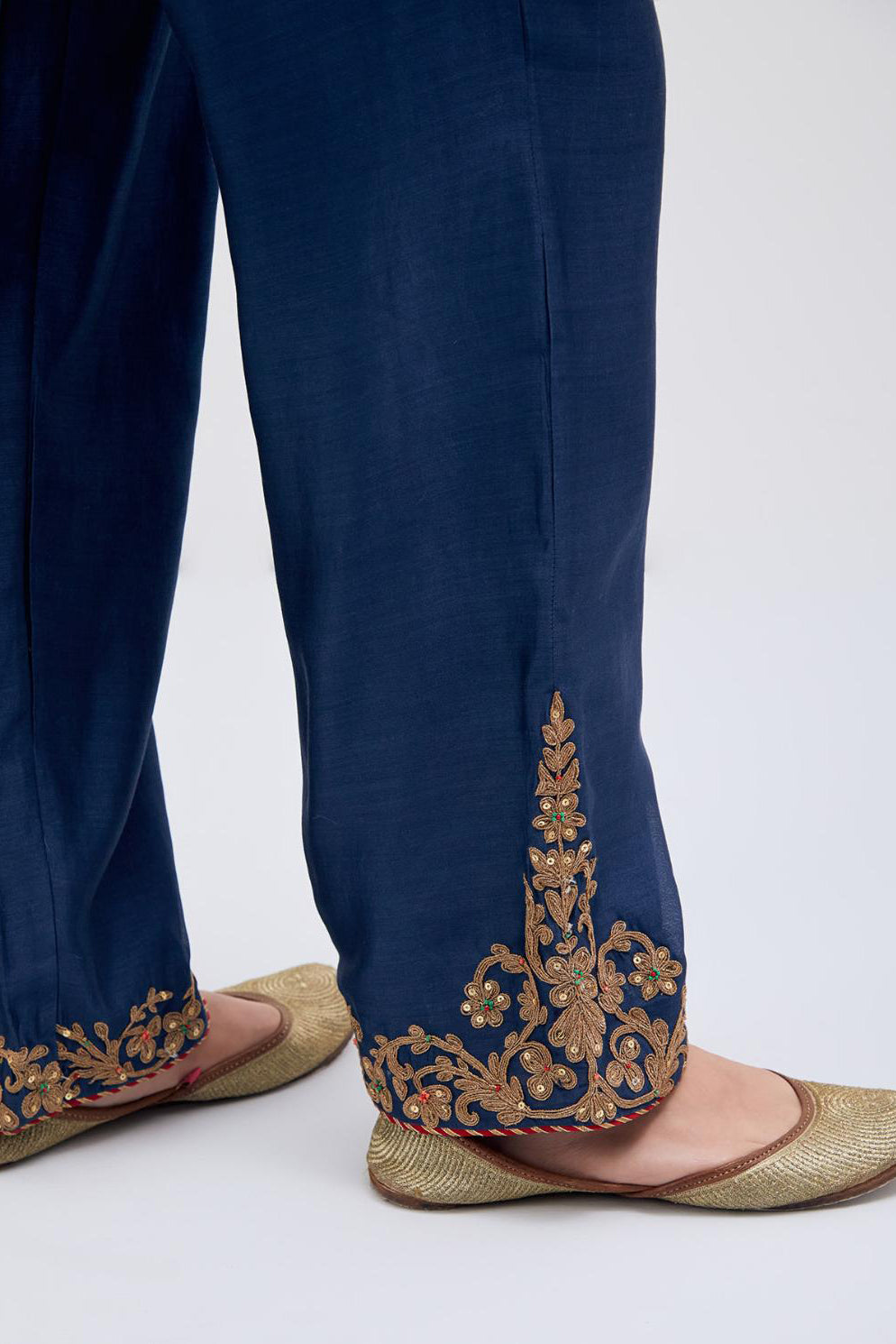 Prussian Blue Silk Chanderi pants with dull gold dori embroidery at hem, highlighted with multi colored beads and gold sequins work.