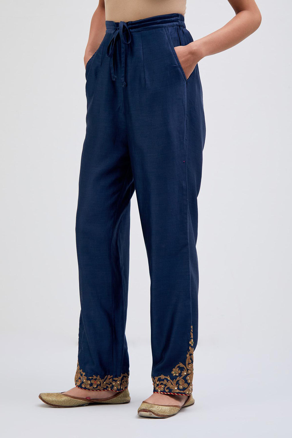 Prussian Blue Silk Chanderi pants with dull gold dori embroidery at hem, highlighted with multi colored beads and gold sequins work.