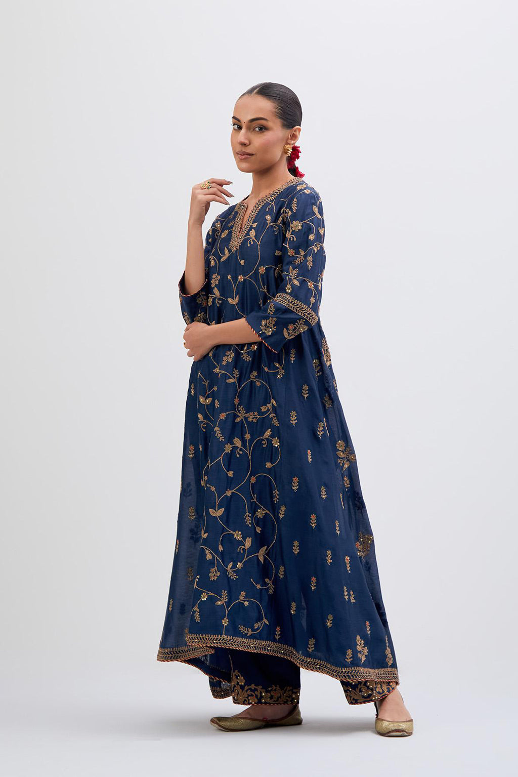 Prussian Blue Silk Chanderi kurta set with asymmetric hem and all-over dull gold dori embroidery, highlighted with multi colored beads and gold sequins.