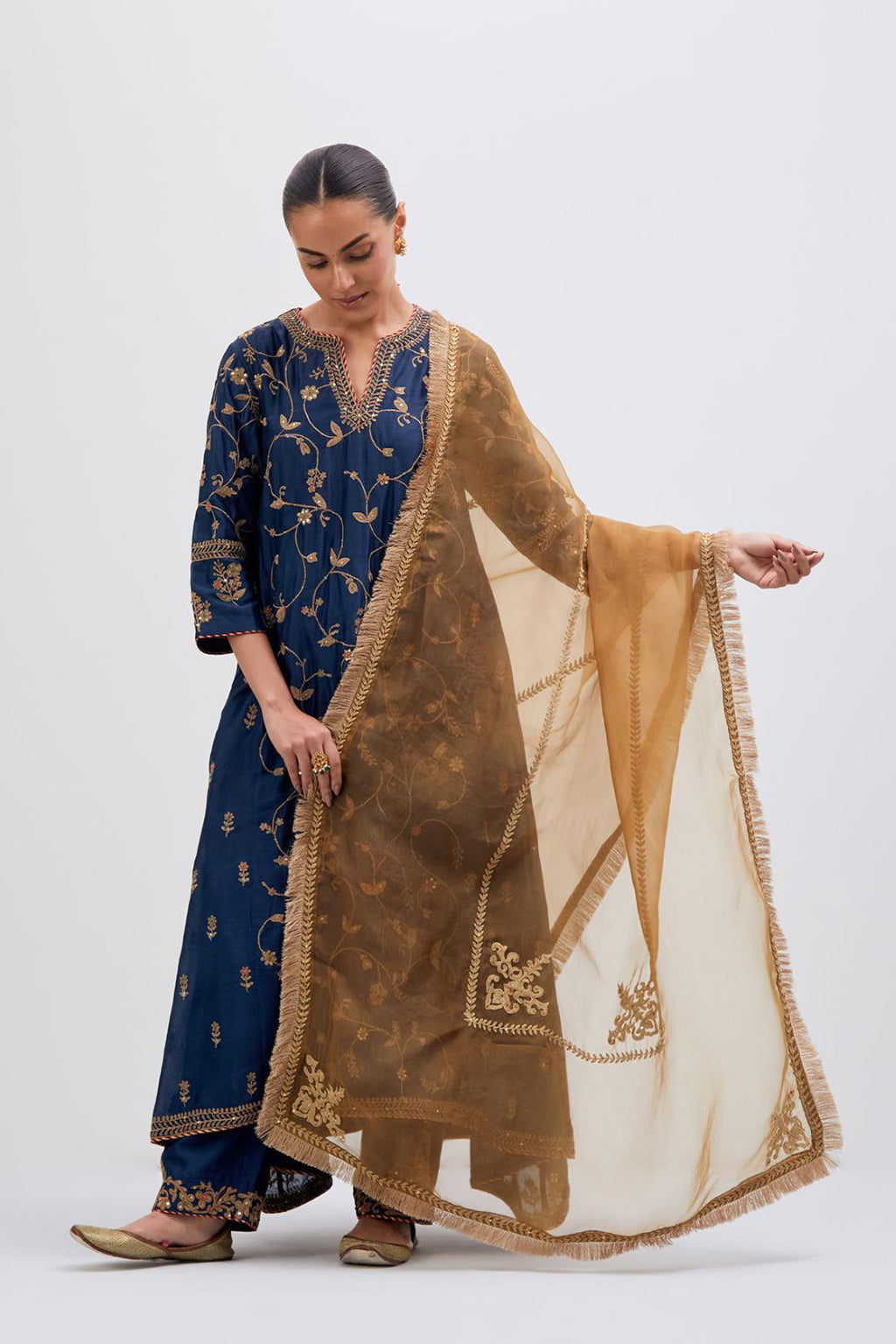 Prussian Blue Silk Chanderi kurta set with asymmetric hem and all-over dull gold dori embroidery, highlighted with multi colored beads and gold sequins.