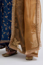 Prussian Blue Silk Chanderi kurta set with asymmetric hem and all-over dull gold dori embroidery, highlighted with multi colored beads and gold sequins.