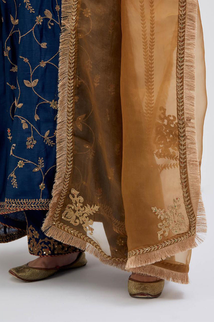 Prussian Blue Silk Chanderi kurta set with asymmetric hem and all-over dull gold dori embroidery, highlighted with multi colored beads and gold sequins.