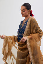 Prussian Blue Silk Chanderi kurta set with asymmetric hem and all-over dull gold dori embroidery, highlighted with multi colored beads and gold sequins.