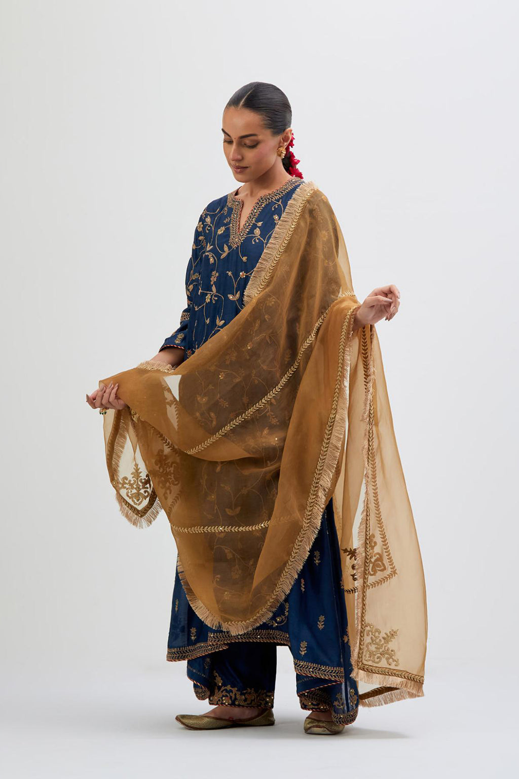 Prussian Blue Silk Chanderi kurta set with asymmetric hem and all-over dull gold dori embroidery, highlighted with multi colored beads and gold sequins.