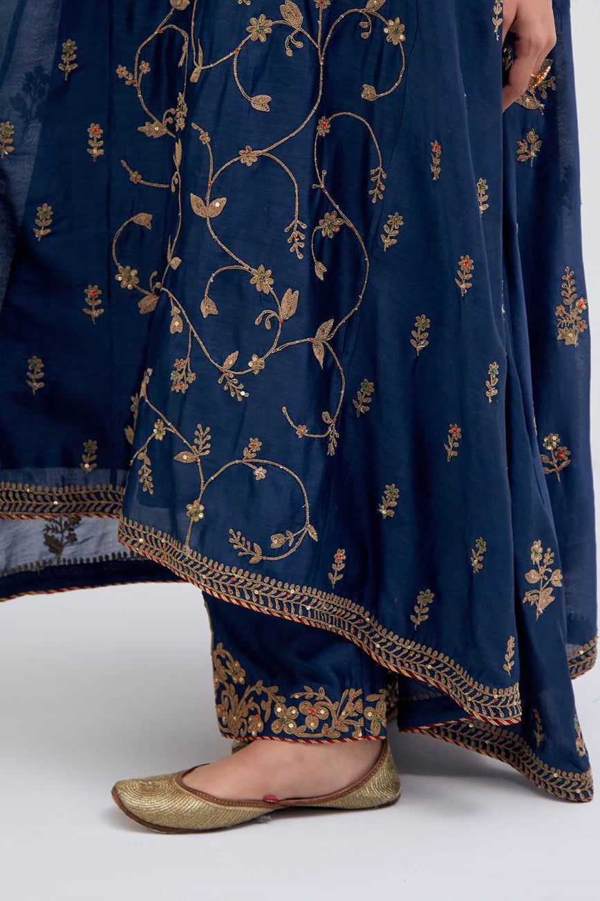 Prussian Blue Silk Chanderi kurta set with asymmetric hem and all-over dull gold dori embroidery, highlighted with multi colored beads and gold sequins.