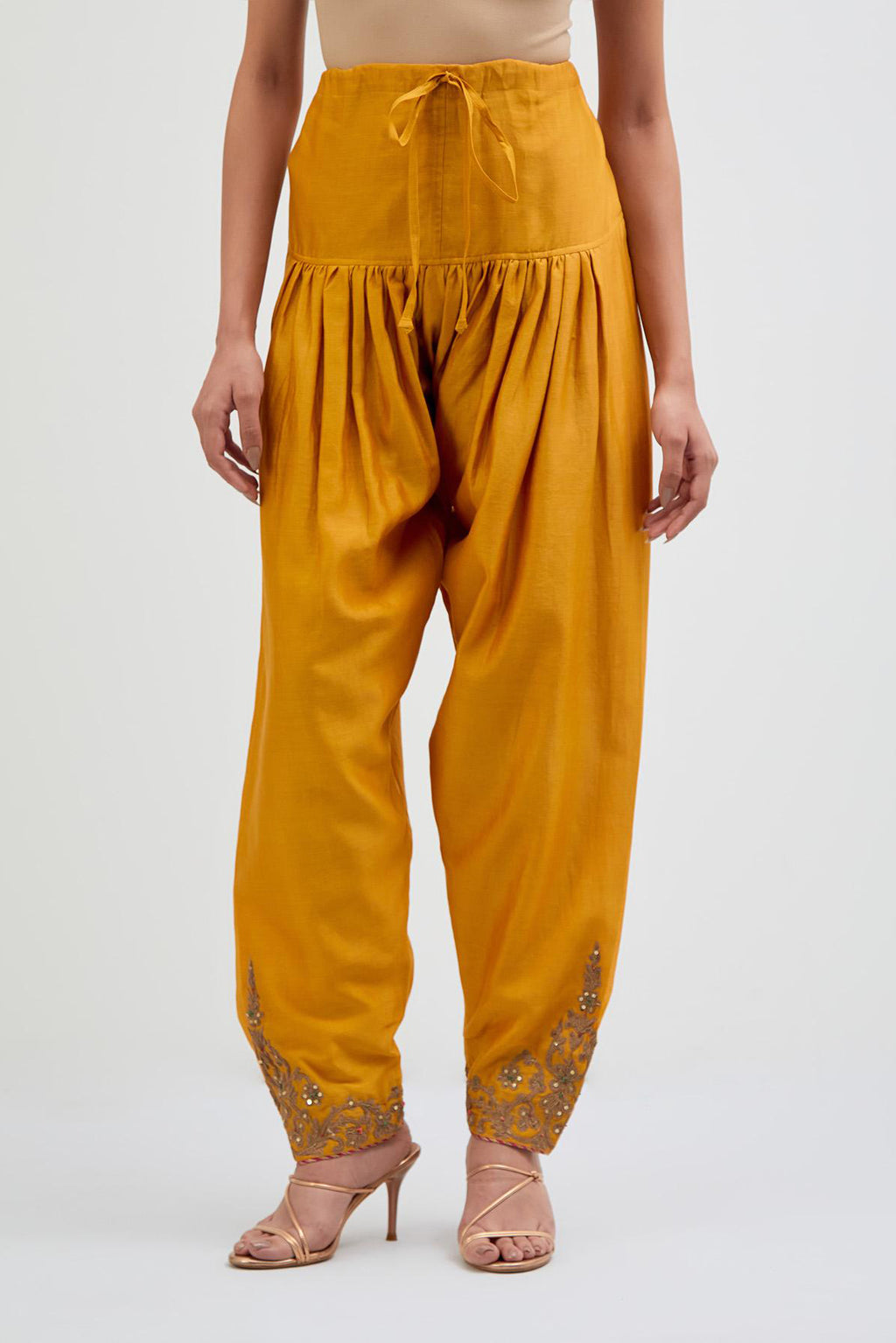 Deep Yellow Silk Chanderi narrow salwar with dori embroidered boota at hem, highlighted with multi colored beads and gold sequins work.