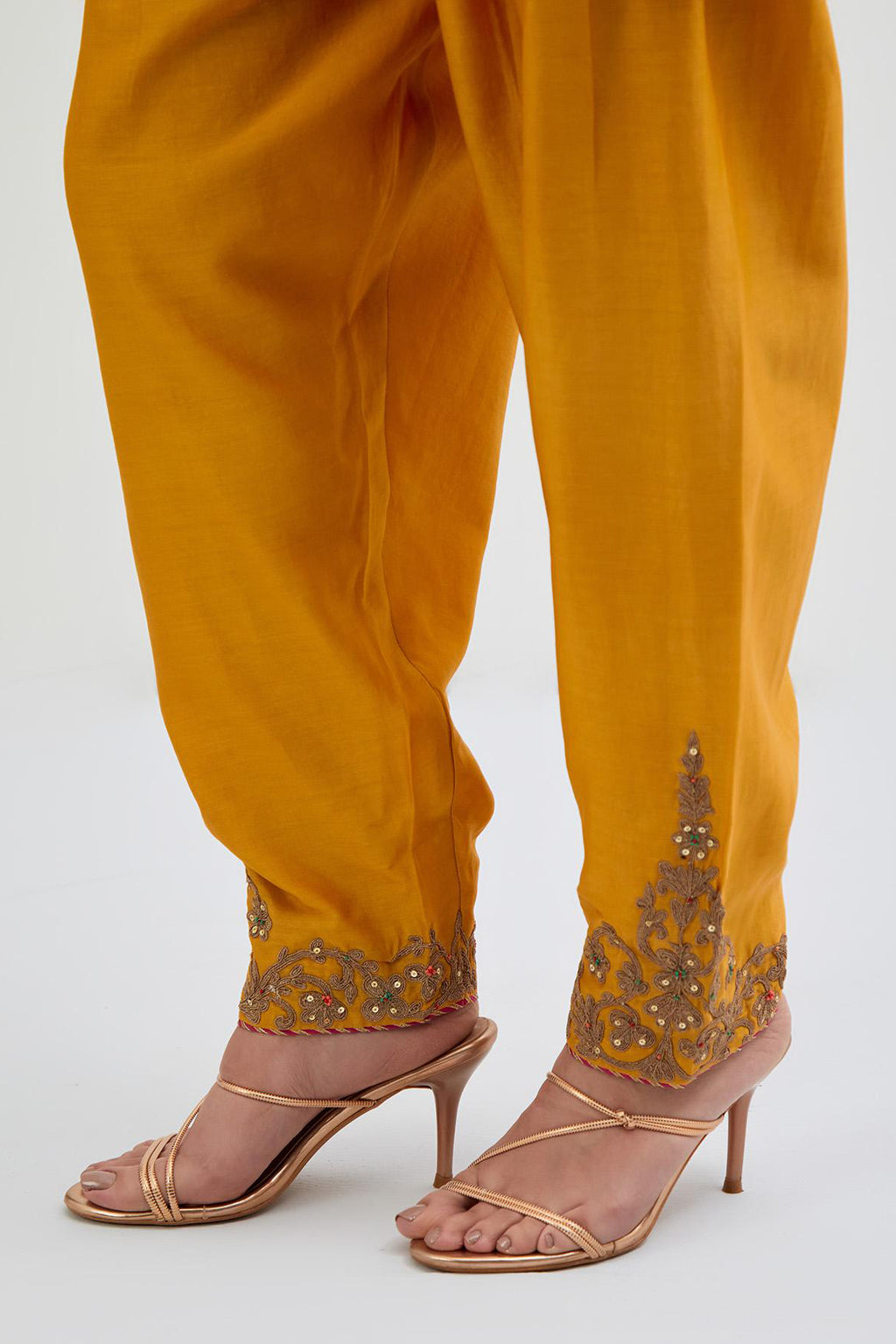 Deep Yellow Silk Chanderi narrow salwar with dori embroidered boota at hem, highlighted with multi colored beads and gold sequins work.
