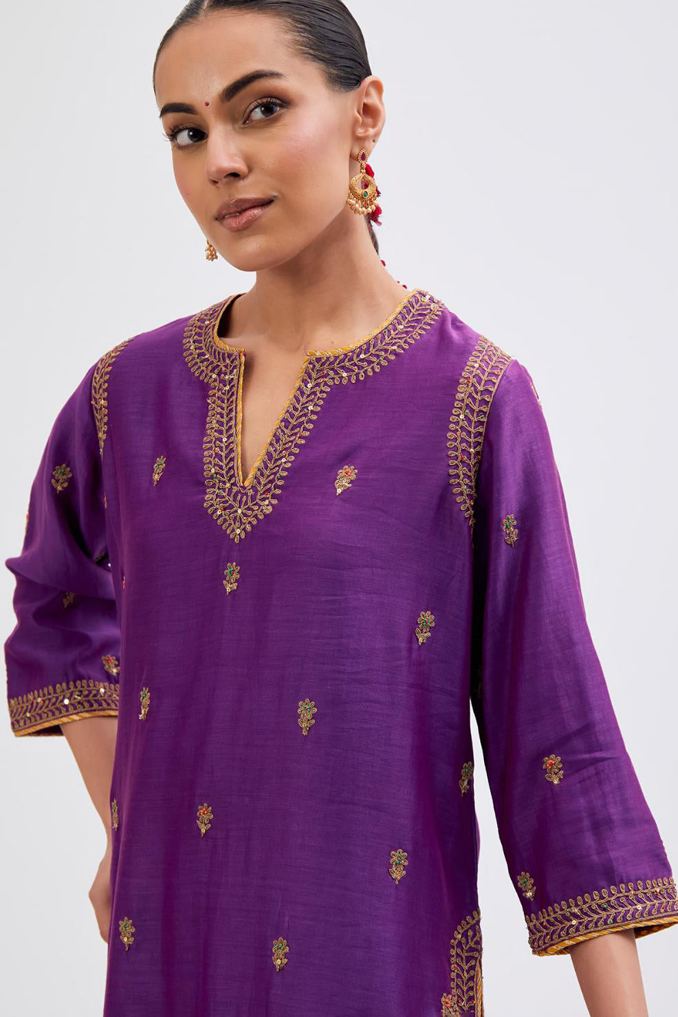 Purple Silk Chanderi straight kurta set with narrow border dull gold dori embroidery at front & back neck, sleeves, side slits and hem, highlighted with gold sequins and bead work.